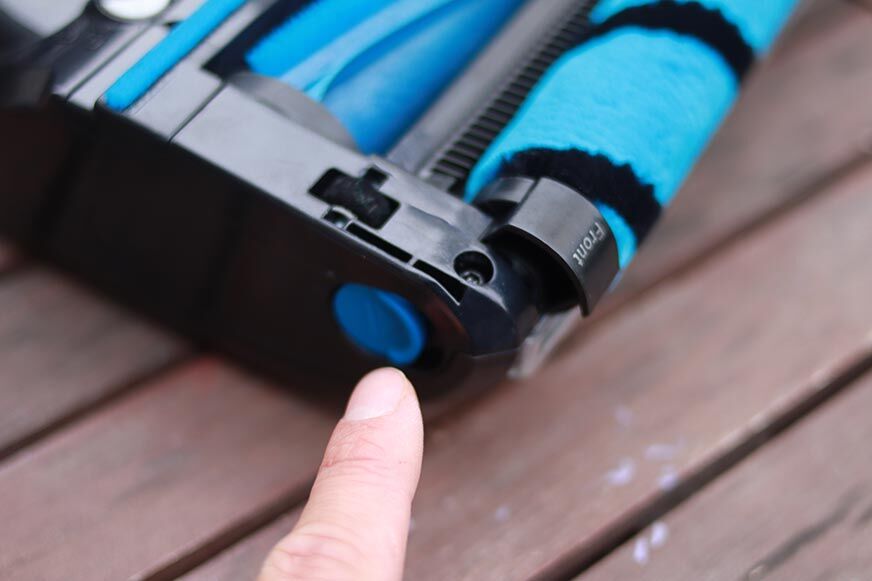 You can see the button to release the soft roller from the floor nozzle.